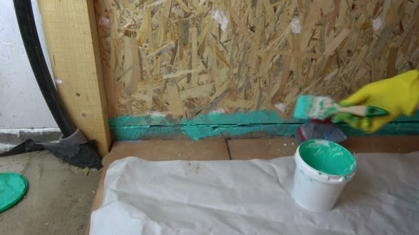 Worker Paintbrush Waterproofing Wooden Bathroom Construction — Stock Video