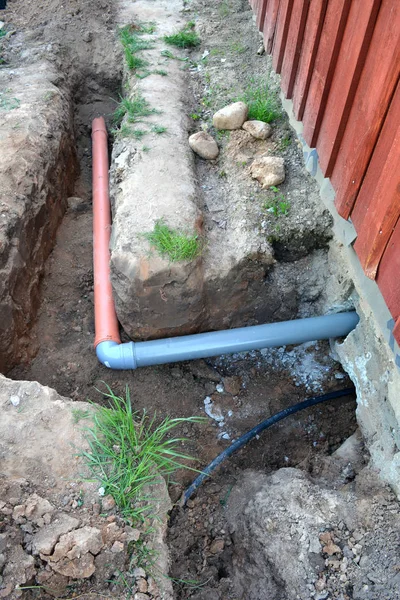Trench near house with water and sewerage pipes — Stock Photo, Image