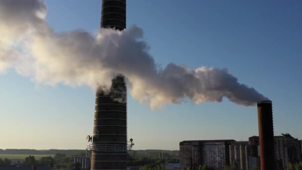 Smoke from boiler house chimney on blue sky background, aerial view — Stock Footage Smoke Boiler House Chimney Blue Sky Background Aerial View Royalty Free Stock Video
