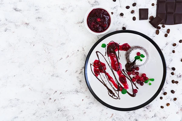 Chocolate fondant with cranberry sauce — Stock Photo, Image