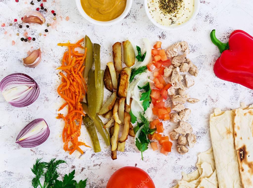 Ingredients for shawarma sandwich on white background. Top view