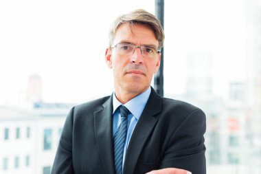 pencerenin kenarında duran işadamı