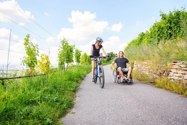 Young Couple In Wheelchair Enjoying Time Outdoors