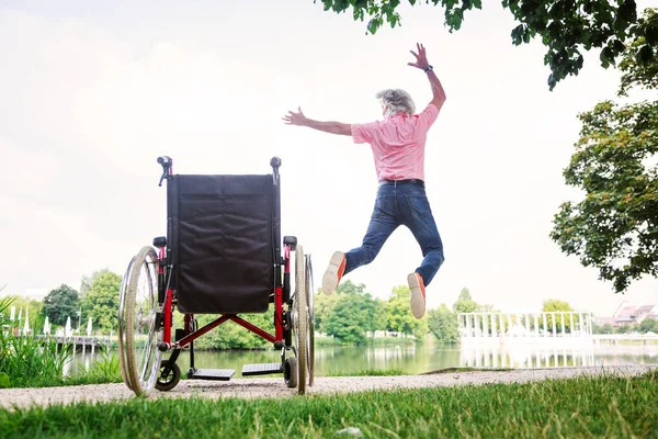 Senior Man Jumping Up From His Wheelchair — Stock Photo, Image