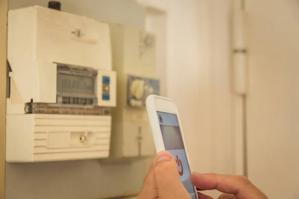 Smart Home: Man Checking Electricity Consumption On Phone