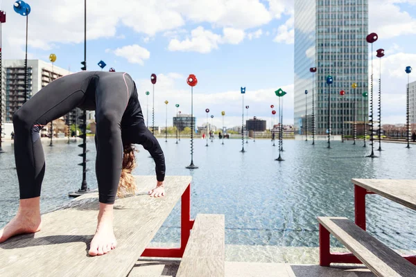 Mulher fazendo ioga perto do lago no cenário urbano, Paris — Fotografia de Stock