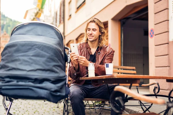 Young Father With Baby Stroller Having Coffee At A Cafe — Stock Photo, Image