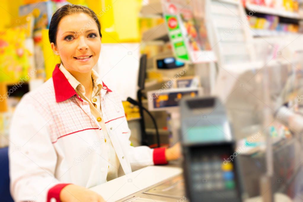 Sales Clerk At A Cash Register In The Supermarket