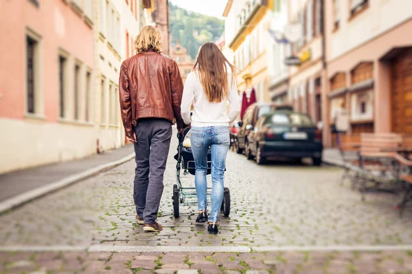 Young Parents With Baby Stroller In The City — Stock Photo, Image