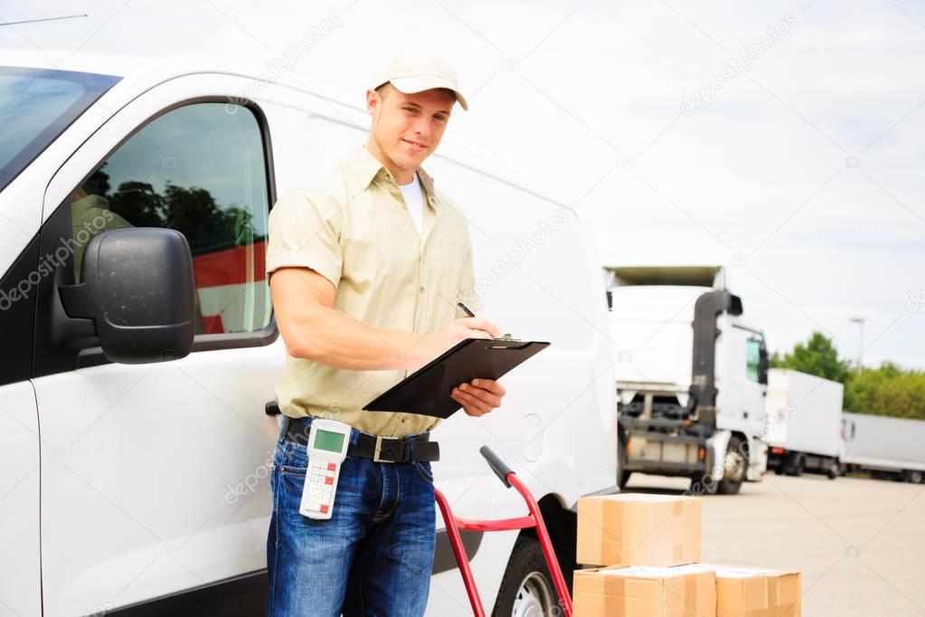 Delivery Boy Standing Next To His Van