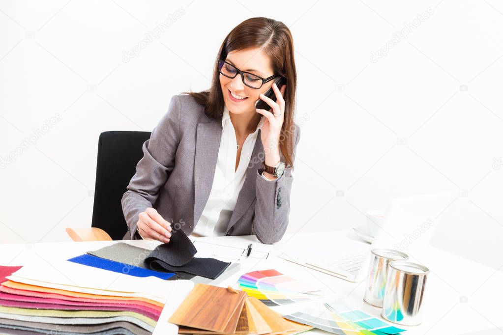 Female Interior Designer At Her Desk