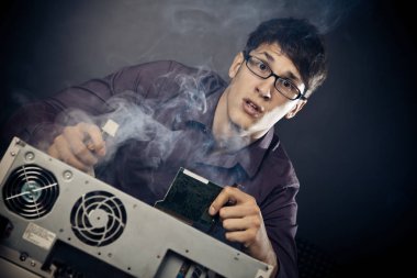 Nerd With Smoke Coming Out Of His Pc clipart