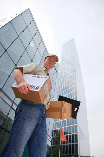 Delivery Boy de pie frente a edificios modernos —  Fotos de Stock