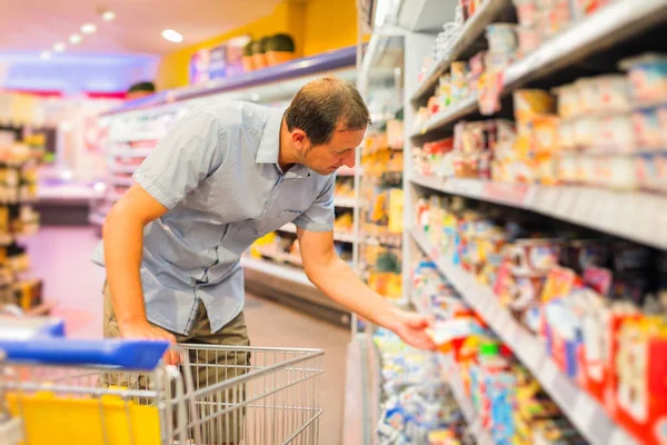 Adult Man At The Supermarket Royalty Free Stock Images