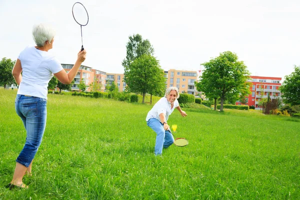 Couple senior jouant au badminton — Photo