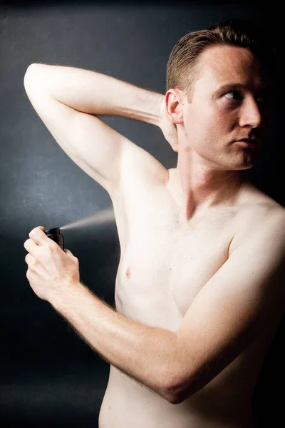 Homem colocando desodorizante — Fotografia de Stock