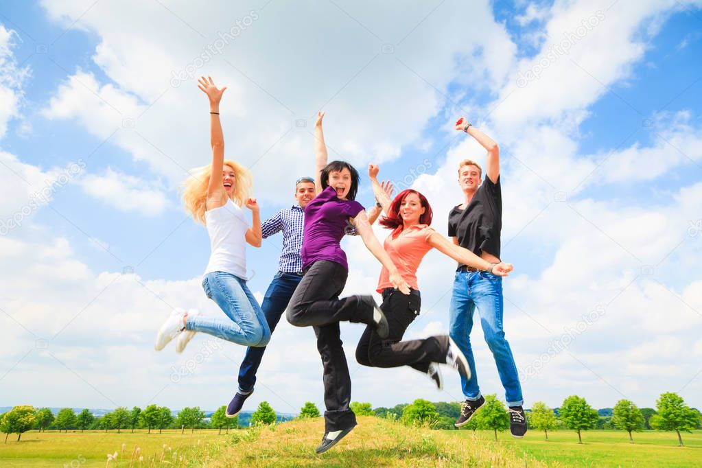 Young People Jumping In Front Of Blue Sky