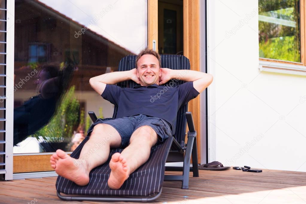 Adult Man Relaxing On Patio