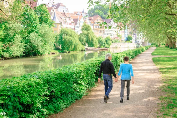 Senior Couple Walking Through A Park — Stock Photo, Image