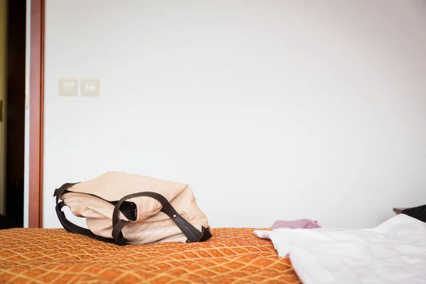 Женский кошелек на кровати отеля — стоковое фото