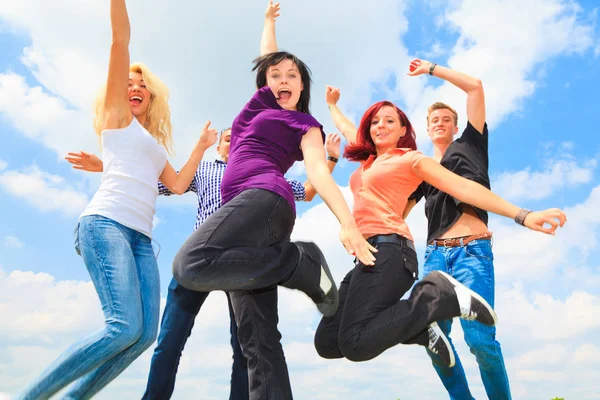 Young People Jumping In Front Of Blue Sky — Stock Photo, Image