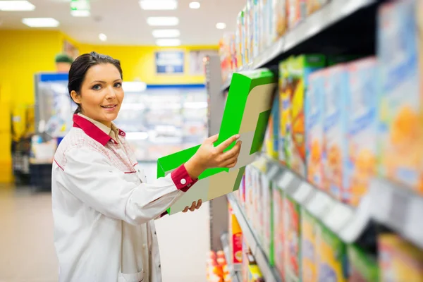 Sales Clerk Refilling Shelves At The Supermarket Stock Image