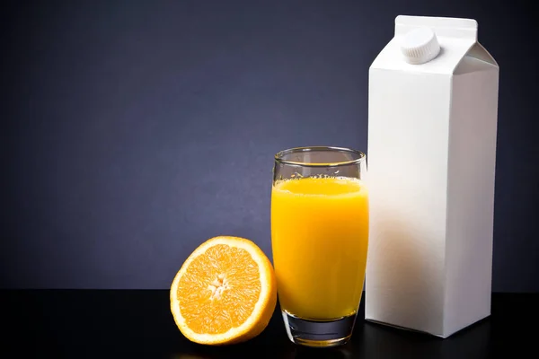Vaso y cartón de zumo de naranja — Foto de Stock