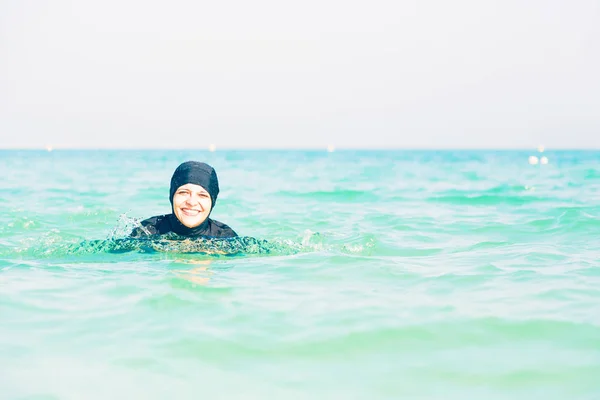 ムスリム、海で泳いでの若い女性 — ストック写真