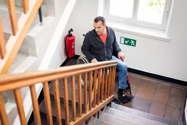 Человек в инвалидном кресле застрял на лестнице — стоковое фото