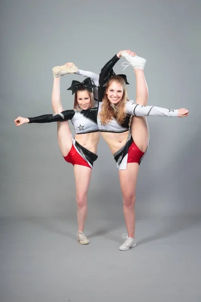 Two Cheerleaders Performing A Bow And Arrow — Stock Photo, Image