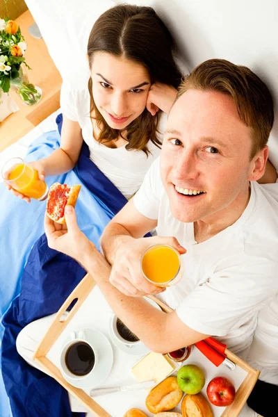 Couple Having Breakfast In Bed Stock Photo
