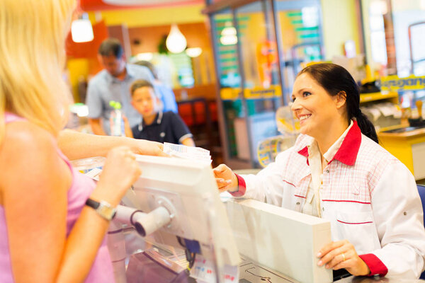 Sales Clerk At A Cash Register In The Supermarket