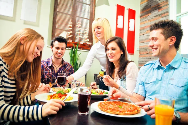 Four Friends Having Lunch At A Restaurant Royalty Free Stock Photos