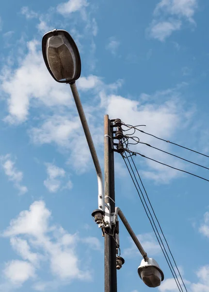 Electric pole with the twin lamp. — Stock Photo, Image