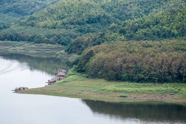 Tranquil lake with the cottage raft in the reservoir. — Photo