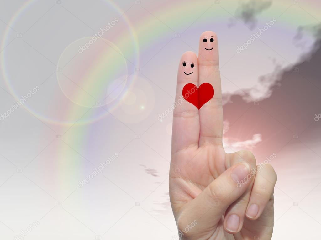 two fingers painted with red heart