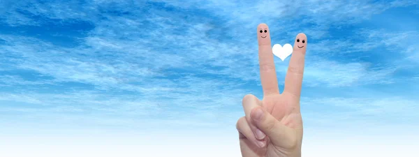 Female fingers painted with heart and faces — Stock Photo, Image