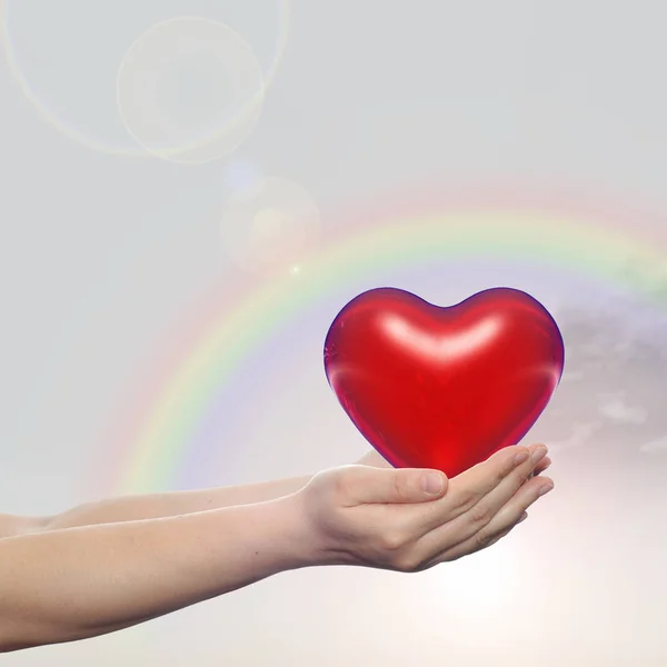 Red heart sign in hands — Stock Photo, Image