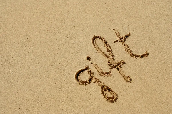 Text auf Sand am Strand — Stockfoto