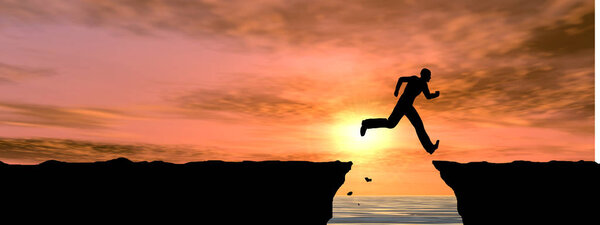 male silhouette jumping over cliff gap