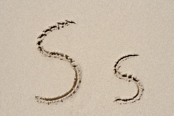 Concept or conceptual sand font or letter set group or collection carved on exotic beach near sea isolated on a sandy background, metaphor to nature, natural, education, character, message or summer — Stock Photo, Image