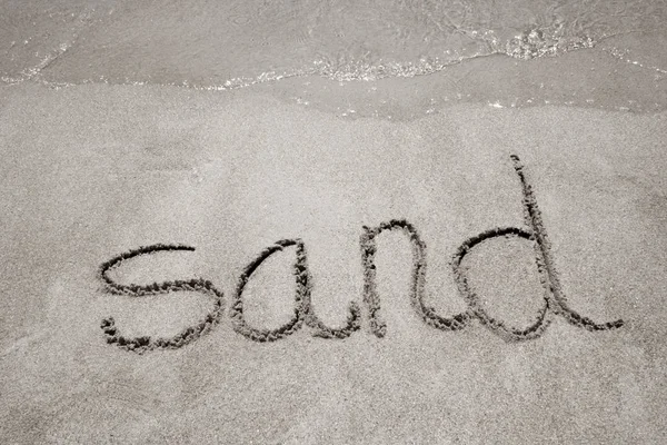 Handgeschreven in zand op een strand zand — Stockfoto