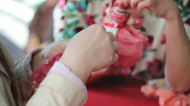 Yong white woman make handmade doll — Stock Video