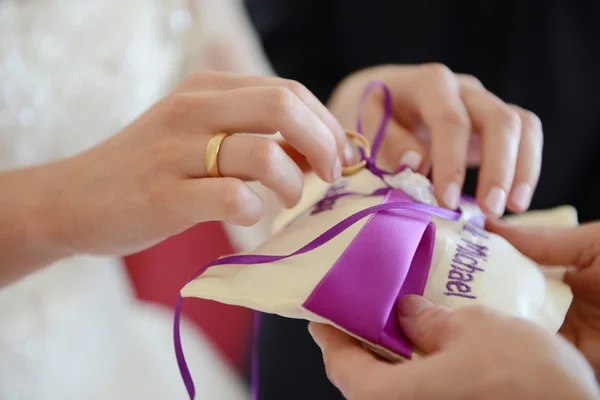 Pillow with wedding rings and bride — Stock Photo, Image