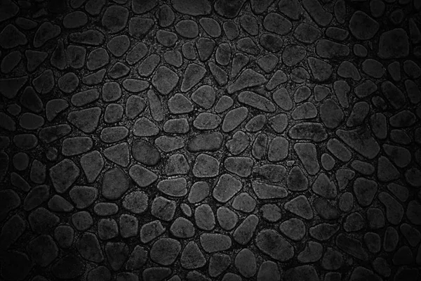 Texture d'un mur noir de petites pierres aux bords arrondis — Photo