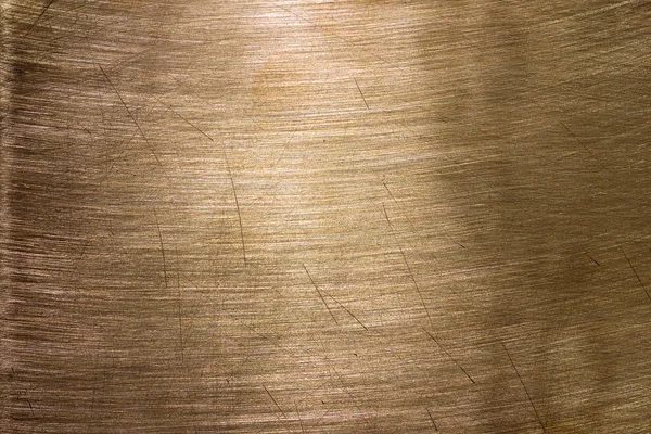 Sarı metal bir yüzeye, doku altın veya arka plan olarak bronz