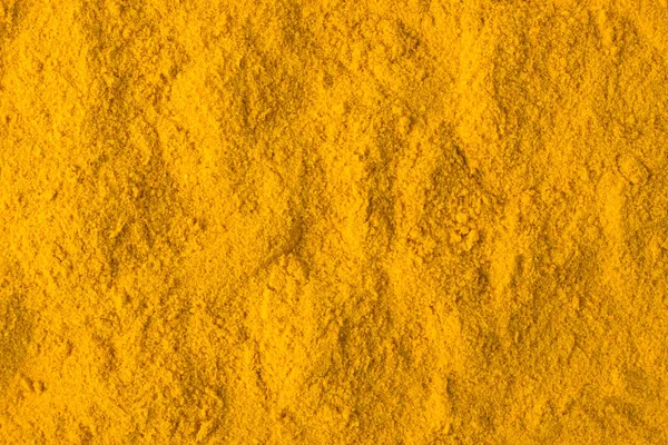 Turmeric powder spice as a background, natural seasoning texture — Stock Photo, Image