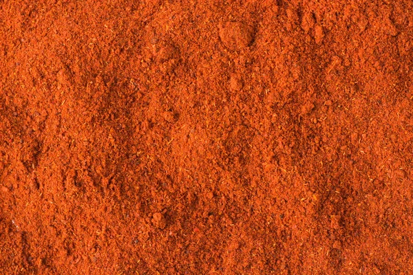 Piment en poudre d'épice comme fond, texture d'assaisonnement naturel — Photo