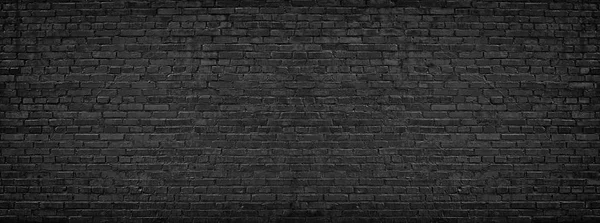 Panorama van zwarte bakstenen muur voor site caps als achtergrond — Stockfoto
