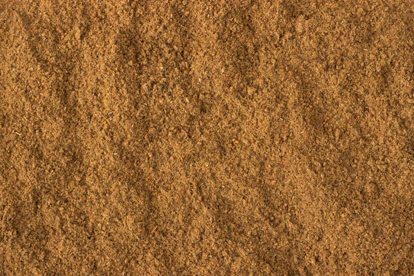 Ground nutmeg powder spice as a background, natural seasoning te — Stock Photo, Image